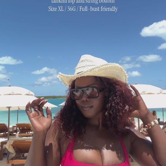 video of founder, shar showing off the tankini top and string bottom in the pink magenta color. Sharon is describing the benefits and additives of the pam tankini top  which includes support, coverage and style.